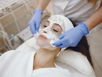 Cosmetologist treats client's skin. Woman with cosmetologist. Lady in a beauty studio.